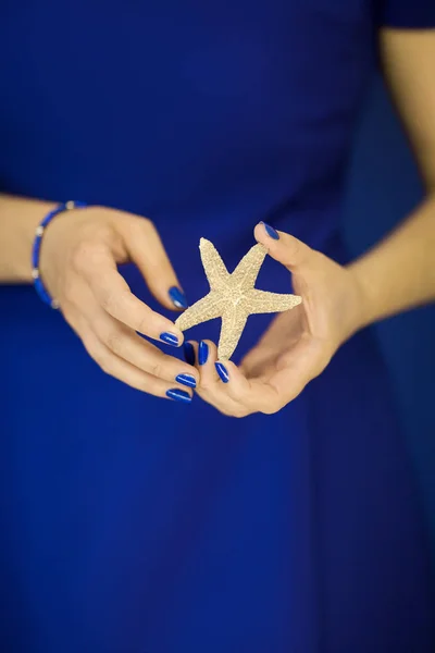 Schöne Frauenhände Mit Perfektem Nagellack Die Kleine Seesterne Vor Blauem — Stockfoto