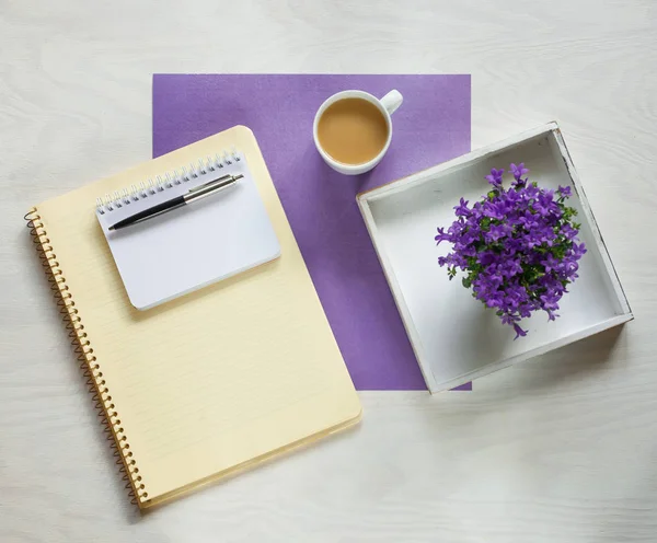 flat lay concept with writing pad, pen and beautiful violet flowers, can be used as background