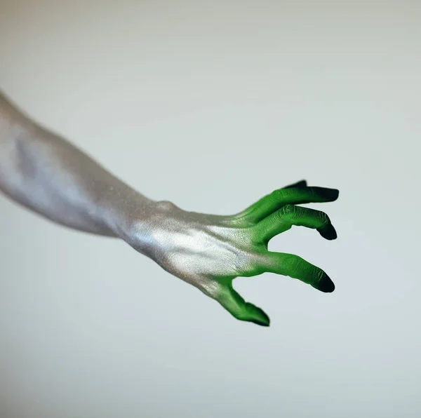 Creepy Halloween monster witch hand with white, green and black in front of white background