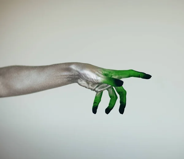 Creepy Halloween monster witch hand with white, green and black in front of white background
