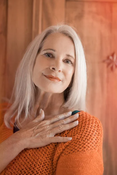 stunning beautiful and self confident best aged woman with grey hair smiling into camera, portrait