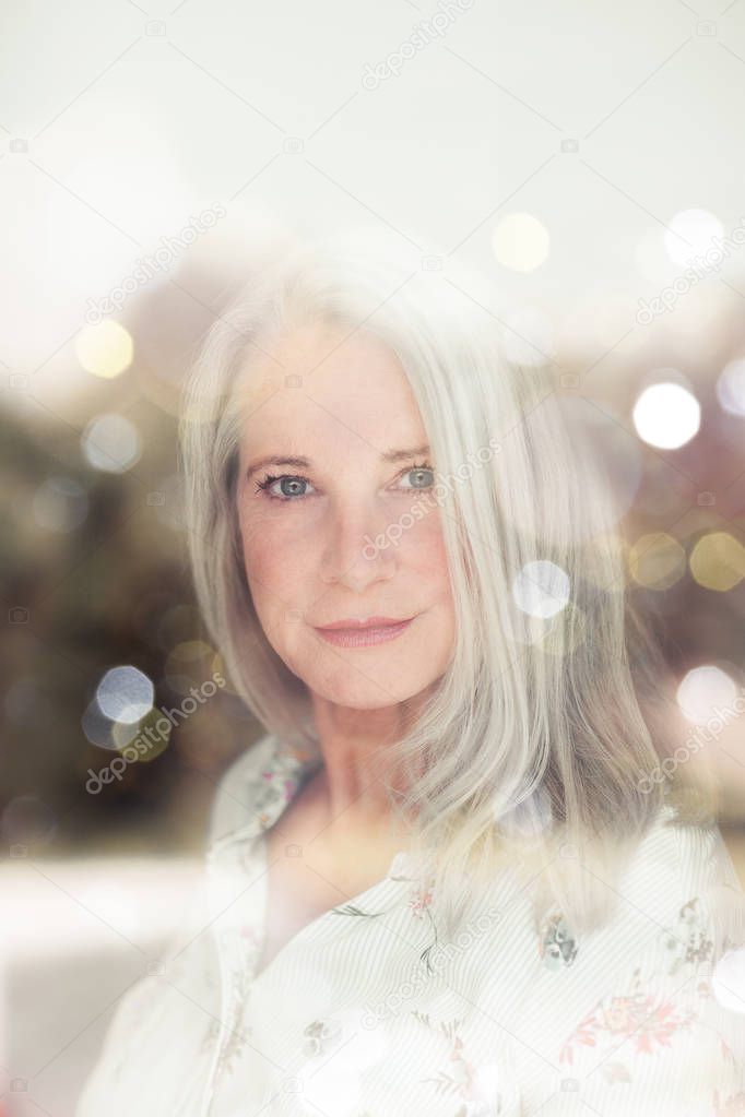 stunning beautiful and self confident best aged woman with grey hair smiling into camera, portrait 