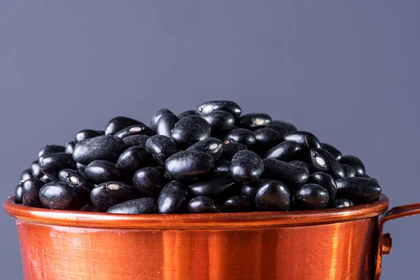 Raw black bean grains seen close up.
