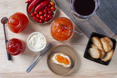 Kaymak ve biber reçelli tostlu bir masa. Arka planda bir bardak üzüm suyu.