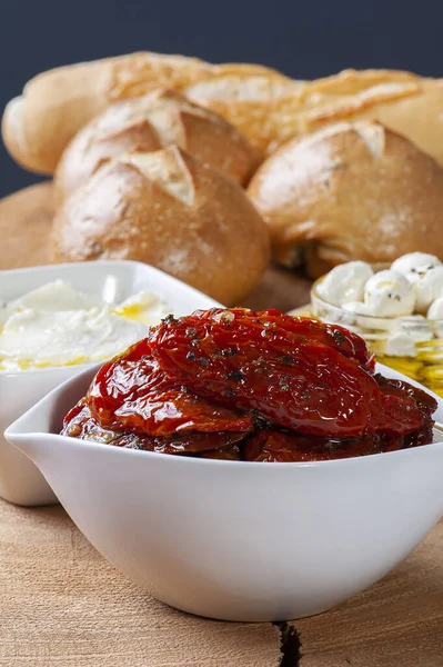 Pomodori Secchi Una Ciotola Bianca Cagliata Pane Sullo Sfondo — Foto Stock