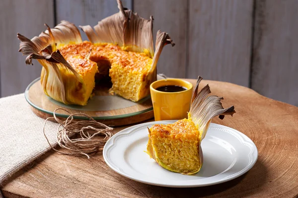 Corn cake in the straw. Homemade cake. Typical of Brazil and South America. Accompanied by a cup of coffee