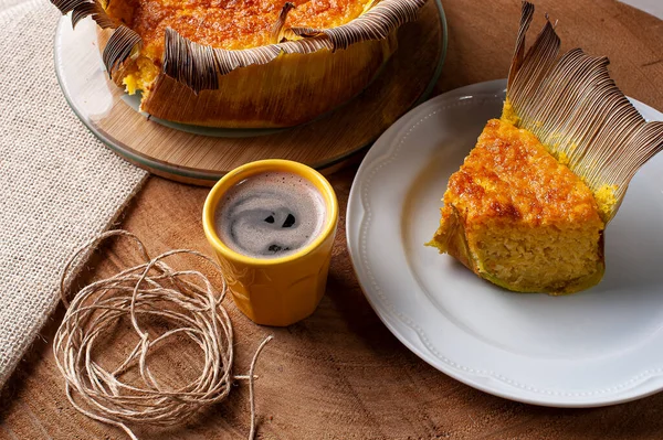 Corn cake in the straw. Homemade cake. Typical of Brazil and South America. Accompanied by a cup of coffee