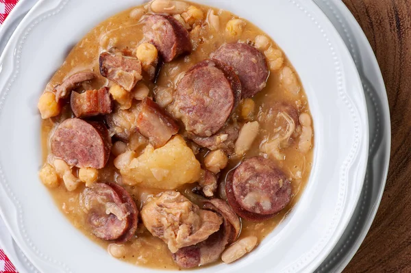 Puchero. Dish made with white beans, chickpeas, sausage, bacon and vegetables. Dish of Spanish origin very common in Brazil and South America. Top view