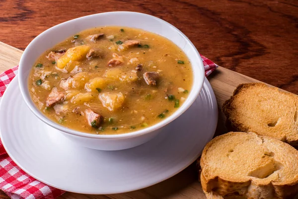 Cassava broth. Creamy broth made with cassava, sausage, bacon and meat.