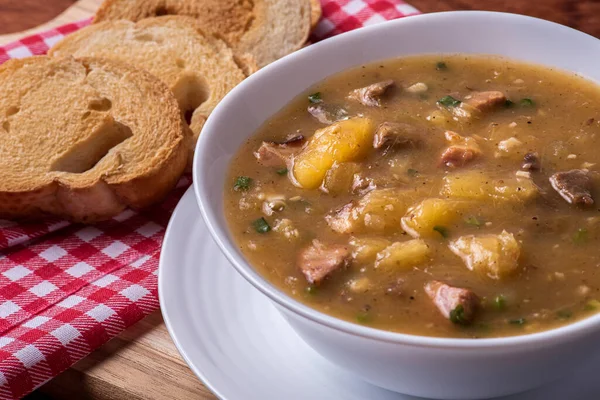 Cassava broth. Creamy broth made with cassava, sausage, bacon and meat.