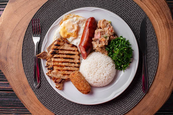 Typical dish of Brazilian cuisine called virado a paulista. Top view.