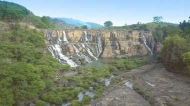 Taş şelale yakın turist üzerinde kamera taşır