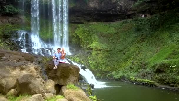 Luftaufnahme Mann Und Mädchen Sitzen Auf Felsen Wasserfall Genießen Landschaft — Stockvideo