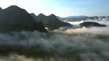 ışık sınırsız beyaz bulutlar tepenin üst düzeyde karanlık dağlarında siluetleri karşı üst görünümünde fantastik sabah güneş ışınları