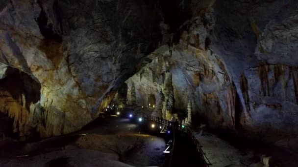 Turistler ışık için köprü boyunca projektörler duvarlar mağara — Stok video