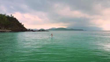 Bayan paddleboard sonsuz okyanusta sörf üzerinde hareket