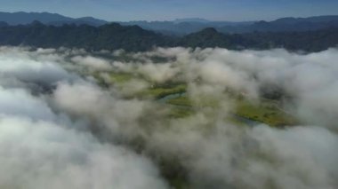Beyaz tepe tepeler girdap gibi bulutların üzerinde casus uçak uçar