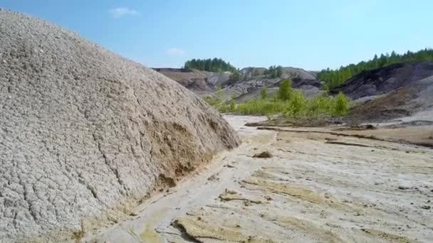 Steep stony slope on old clay pit and canyon bed — Stock Video