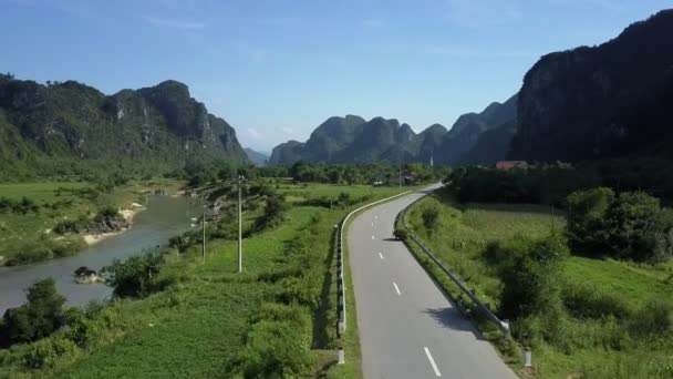 Aerial view bikers in uniform stand on road near river — Stock Video