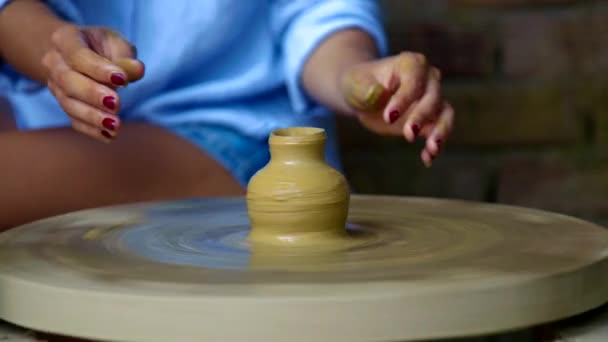 Closeup girl hands make clay vase neck on potter wheel — Stock Video