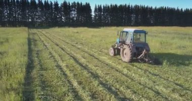 güzel yaz manzara kırsalında karşı saman için çim biçme traktörü üst görünüm çiftçi çalışır
