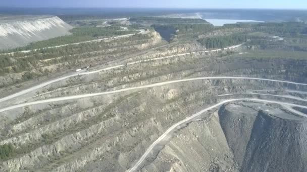 Aerial view asbestos mine open pit terrain at distant lake — Stock Video