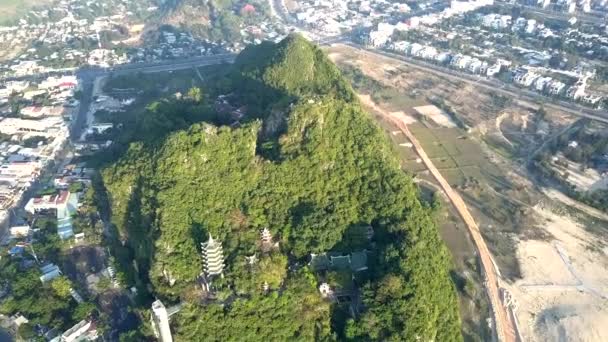 Vista superior pagoda templo en la colina verde entre la ciudad moderna — Vídeo de stock
