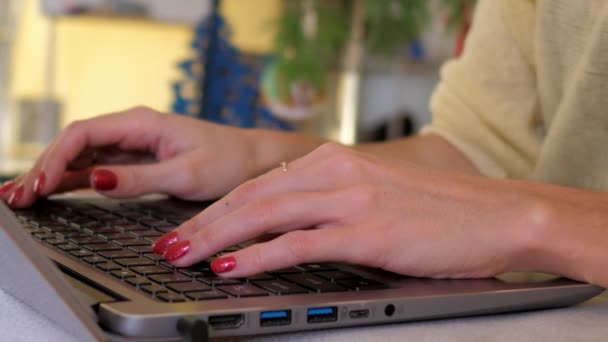 Slow motion macro girl types text on notebook keyboard — Stock Video