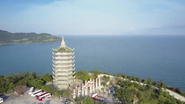 Aerial view huge pagoda on hill among trees on ocean coast — Stock Video