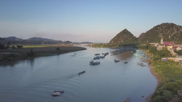 Luchtfoto boten in rivier baai met bridge tegen hillpeaks — Stockvideo