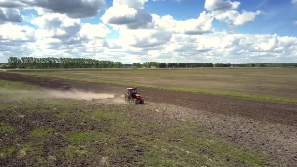 Flycam si sposta dalla vista frontale a quella laterale del trattore sul campo — Video Stock