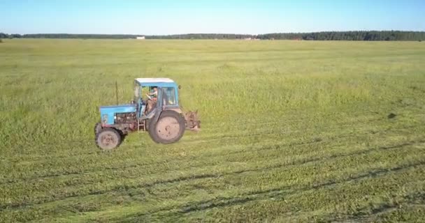 Experienced driver drives hay baler cutting off grass — Stock Video