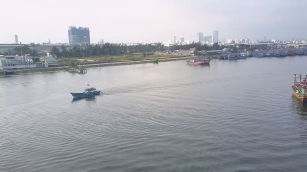 Small motorboat sails by embankment quays with mooring boats — Stock Video