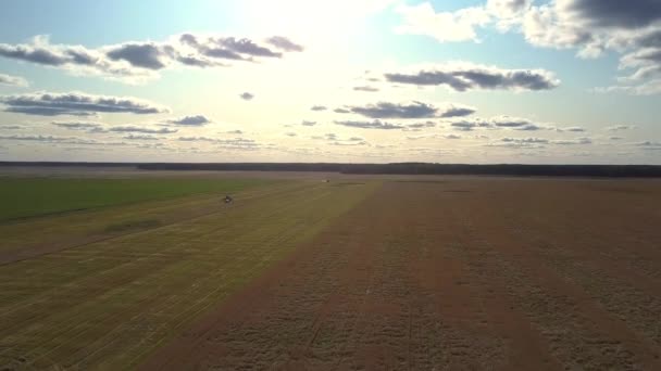 Bird eye flight harvester and gray car stand on field — Stock Video