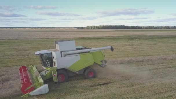 드론은 필드에 거대한 수확기 운전 의 앞에 비행 — 비디오