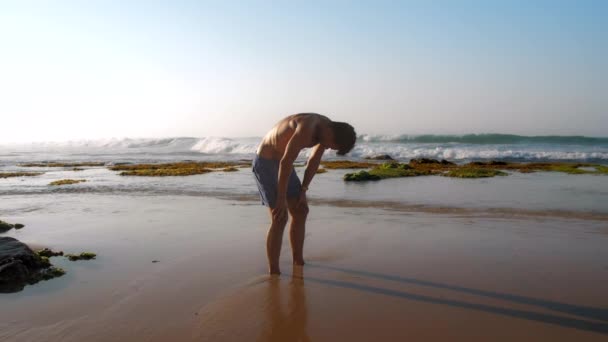 Handsome sportsman meditates in yoga pose extreme slow — Stock Video