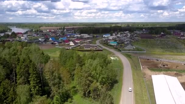 Automobile drives along gray road in modern village — Stock Video