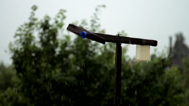 Black handmade windmill rotates slowly on rain weather — Stock Video