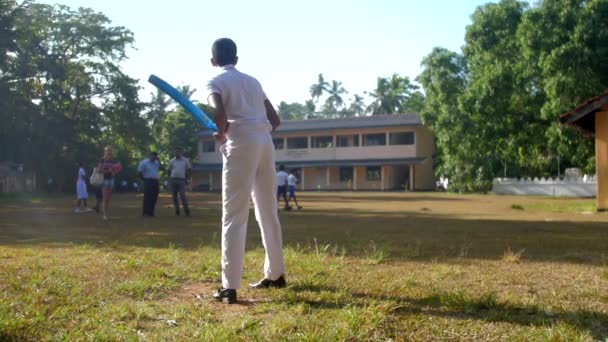 Menino de uniforme escolar fica no playground lento — Vídeo de Stock