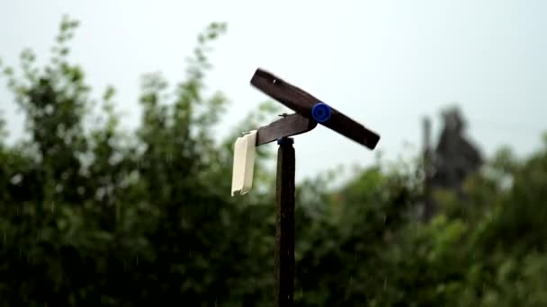 Black handmade windmill rotates after rain under grey sky — Stock Video