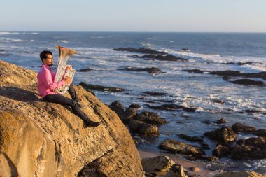 Müzisyen oynamak Tuba okyanus kıyısında. 