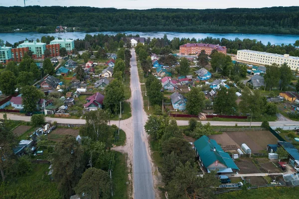 Bird\'s eye view of central street and roofs of houses in urban-type settlement of Leningrad region, Russia.