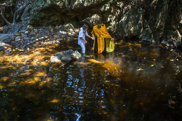 KOH CHANG, THAILAND - MAR 10, 2018: During rites Baptism (immersion in water) - the first and most important Christian sacrament. There are currently 10 Orthodox parishes in Thailand.