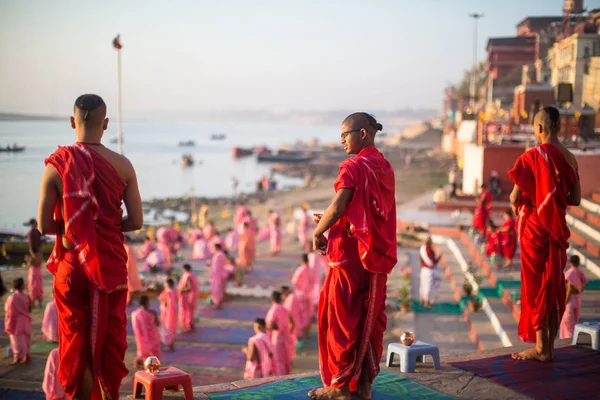 Varanasi, Hindistan - 18 Mar 2018: Genç hindu Rahipler şafak Ganj kıyısında karşılamak için bir tören yapmak ve Hint ve bayrağını yükseltmek. Varanasi Hinduizm 7 kutsal şehirlerden biri. 