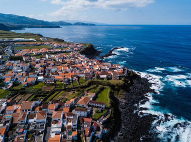 Bird's eye view of the ocean surf on the reefs coast of San Miguel island, Azores, Portugal.  clipart