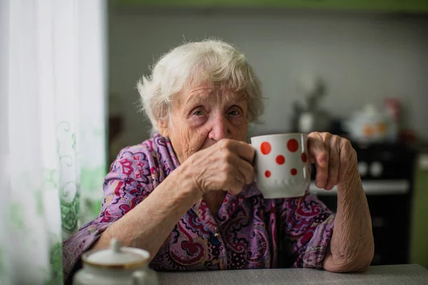 Portrait Elderly Woman Sitting Table Drinks Tea — Stock Photo, Image