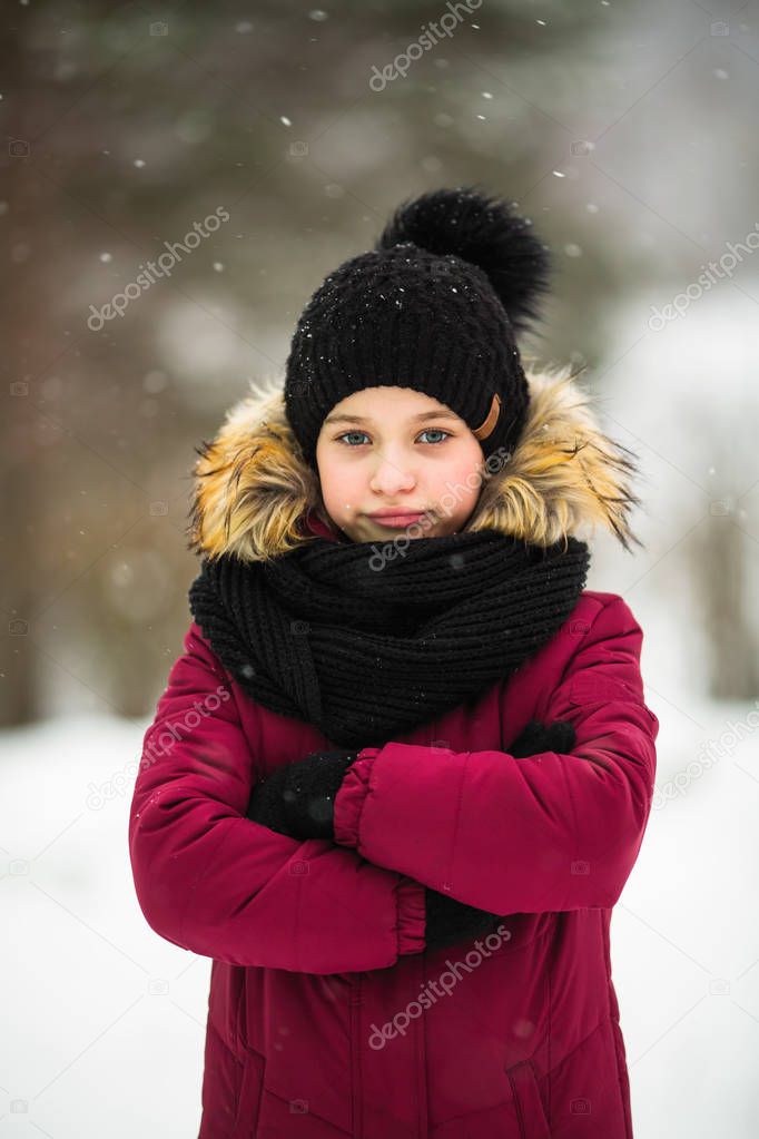 Little cute girl portrait in snow winter.