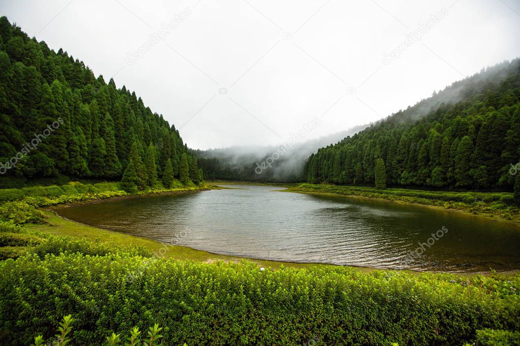 Lake with fog creeping through the water. Azores - Portugal
