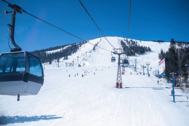 Sheregesh, Rusya - Mar 10, 2019: Kar yamaç teleferik dağ Shoria içinde gelen bir bakış. En popüler kış spor tesisi şimdi nerede fazla milyon turist.