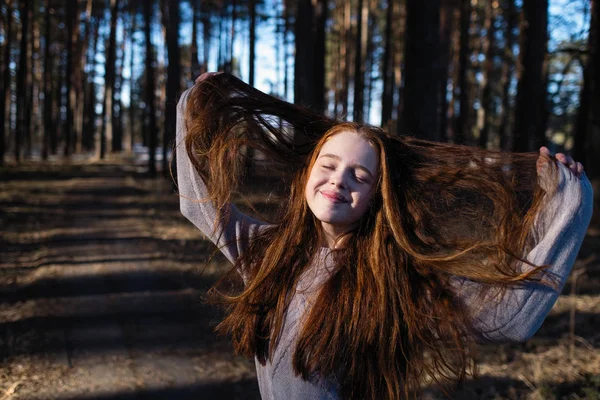 Urocza Nastolatka Długimi Jasnymi Czerwonymi Włosami Pozującymi Kamery Sosnowym Parku — Zdjęcie stockowe